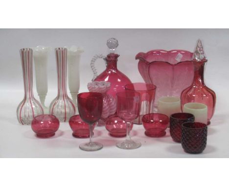 A collection of cranberry glass to include four low vases, a pair of slender vases, a pair of opaline stemmed and waisted vas
