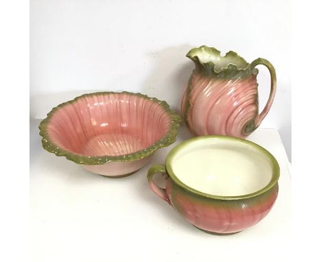 A Victorian majolica wash basin, of naturalistic form, in pinks and greens (46cm x 13cm x 39cm), with matching water jug and 