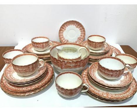 A thirty eight piece English Edwardian china tea service with burnt umber transfer printed foliate border and gilt rims, comp