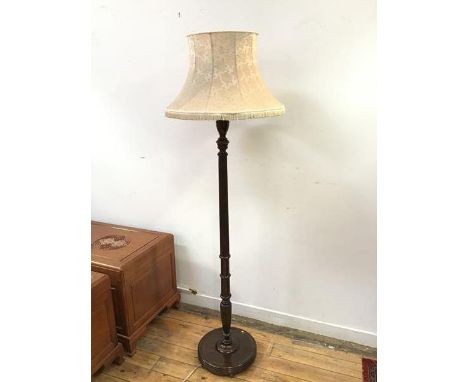 A 1920s standard lamp with turned body on circular reeded base, on bun feet, complete with shade (h.175cm to top of shade x d