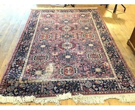 A Mossoul Louis de Poortere machine made rug, the centre panel with three rows of stylised medallions enclosed within a multi