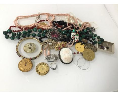 An assortment of costume jewellery including a malachite bead necklace, a coral necklace, a WWI Commemorative medal, a butter