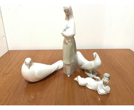 A Spanish Nao porcelain figure of a Recumbent Cherub, a pair of Nao porcelain Doves and a Nao porcelain figure, Lady with Rab