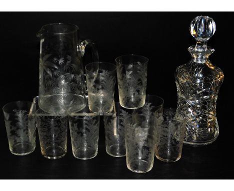 A Victorian cut glass water jug, etched with palm trees and flowers, together with nine tumblers and a cut glass decanter and