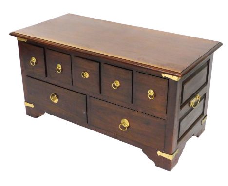A 20thC Eastern hardwood chest, with five square drawers over a pair of long drawers, raised on bracket feet, 53cm high, 102c