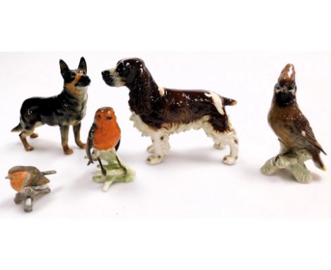 A group of Goebel porcelain animal figures, comprising a German Shepherd, 17cm high, English Springer Spaniel, 18cm high, two
