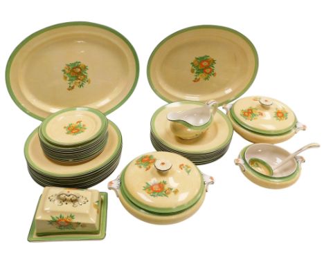 An early 20thC Booths pottery dinner service, printed and painted with flowers, on a yellow floral ground, within a similar g