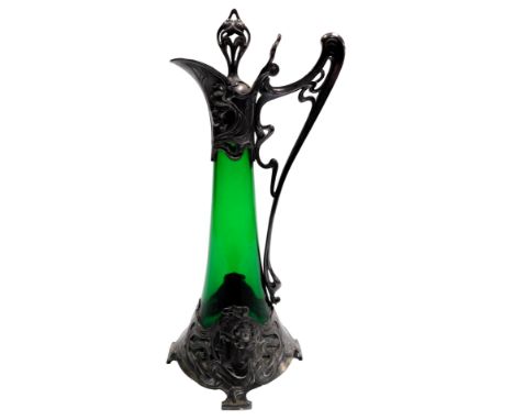 A WMF Art Nouveau pewter and green glass decanter, and stopper, of outswept form, with a sinuous scroll handle, and base moun