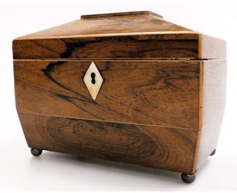 A Regency rosewood sarcophagus tea caddy, with a faux ivory escutcheon, the hinged lid opening to reveal twin lidded compartm