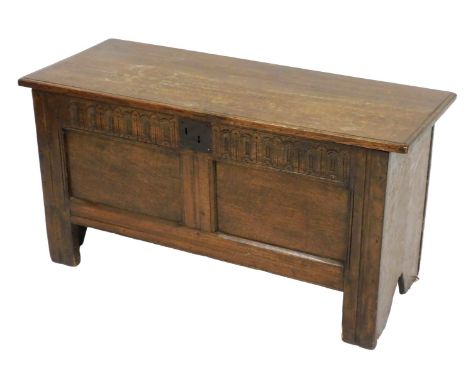 A 17thC oak coffer, with a carved frieze and double panelled front, raised on stiles, 56cm high, 107cm wide, 43cm deep.