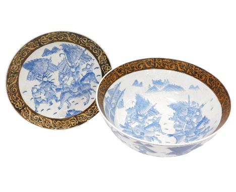 A 20thC Chinese porcelain bowl, decorated with fighting figures on horseback and swordsmen in blue and white having a dark br