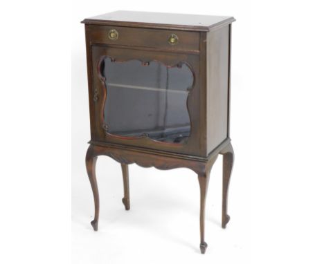 A Victorian mahogany display cabinet, with a single drawer over a shaped glazed door, enclosing a single shelf, raised on cab