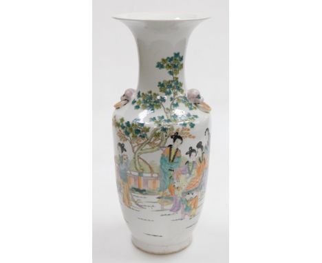 A Chinese famille verte porcelain vase, with dog of fo and ring handles, painted with seated and standing women in a garden, 