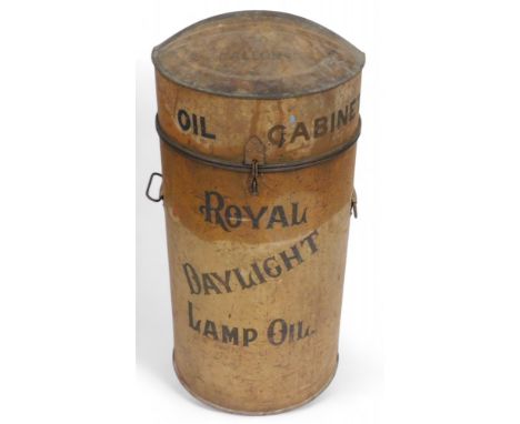 A vintage metal Royal Daylight Lamp Oil Cabinet, of cylindrical form, painted red, the hanged lid opening to reveal a brass t