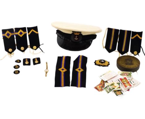 A Royal Naval officer's peaked cap, by Bernards, together with shoulder and arm stripes, for a Sub Lieutenant Engineer branch