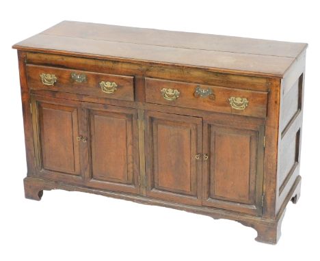 A George III oak dresser base, with two frieze drawers over four panelled doors, raised on bracket feet, 70cm high, 132cm wid