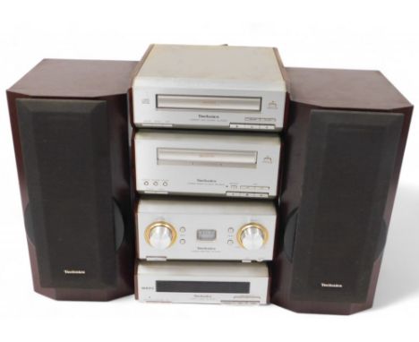 A Technics music centre, with faux walnut side panels, comprising a stereo amplifier, stereo tuner, compact disc player, and 