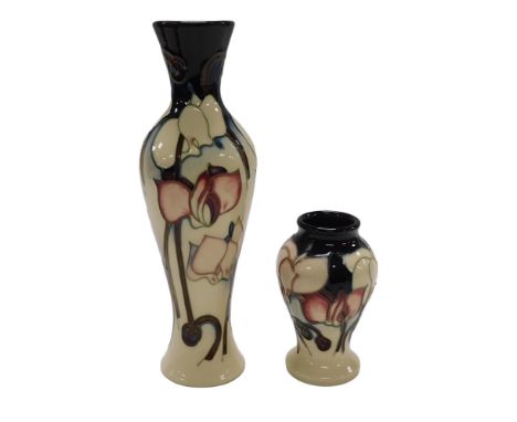 A Moorcroft pottery Cyclamen pattern vase, designed by Emma Bossons, impressed and painted marks, boxed, 21cm high, and a sma