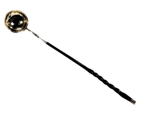 A George III white metal toddy ladle, the plain silver bowl with everted rim set with a gilded shilling dated 1797, with twis