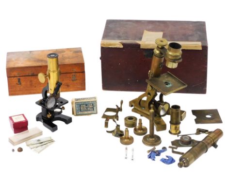 A 19thC brass monocular microscope, boxed, and a student's brass and cast iron microscope, with slides, boxed.