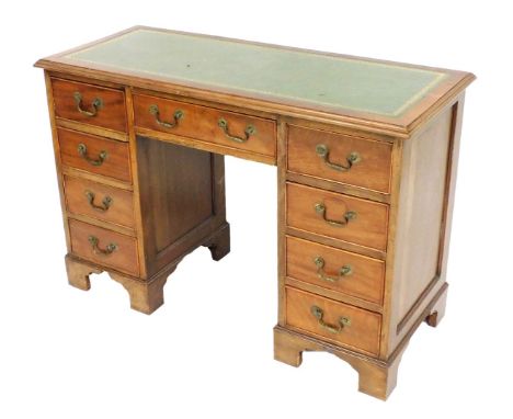 A 20thC mahogany twin pedestal desk, with a gilt tooled green leather top, above a central drawer flanked by eight drawers, r