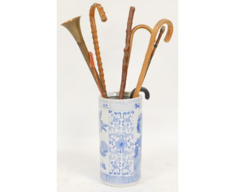 A Chinese blue and white pottery stick stand, decorated with panels of birds and flowers, 44cm high, containing assorted walk