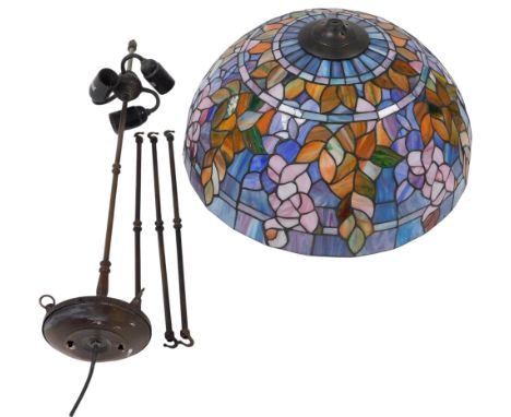 A Tiffany style glass ceiling light, with a triple lamp fitting, the shade decorated with flowers and leaves, 49cm wide.