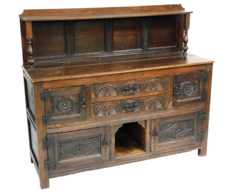 A Victorian oak sideboard, with a shelf topped four panelled back, on turned supports, over two central long drawers flanked 