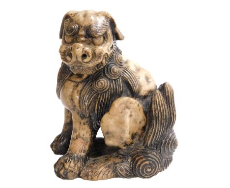 A fine Qing Dynasty Chinese soapstone figure of a seated Buddhist lion in powerful pose, the underside of the left leg with l