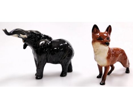 A Beswick pottery figure modelled as an elephant, with trunk raised, 12cm high, and a fox, 12.5cm high.