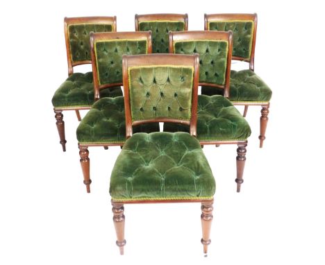 A set of six early Victorian mahogany dining chairs, upholstered in button back and overstuffed green draylon, raised on turn