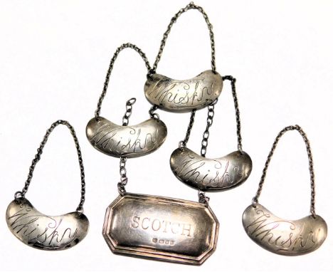 Five George V silver Whisky decanter labels, Birmingham 1933, an Elizabeth II silver Scotch decanter label, London 1971, 0.83