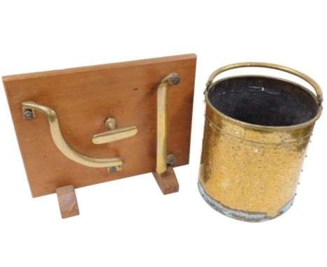 An early 20thC brass coal bucket, of cylindrical form decorated with a band to the top and base decorated with roundels, with