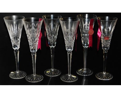 Six Waterford crystal The Twelve Days of Christmas champagne flutes, five bearing ribbons and seals, 26cm high.