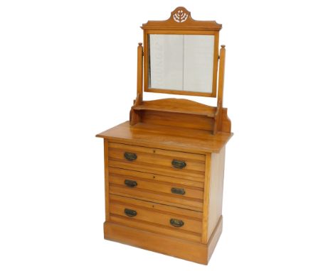 A Victorian satin walnut dressing chest, with a rectangular swing frame mirror, fronted by a small shelf, above three long dr