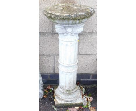 A concrete sundial stand, with a circular top, raised above a capital topped column, on a square base, 94cm high, 42cm wide.