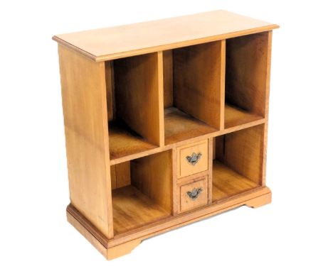 An oak hi-fi cabinet, by Michael Griffin, of rectangular section, with three recesses, above two small drawers flanked by two