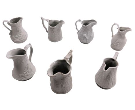 Seven Portmeirion bisque porcelain relief moulded jugs, each of varying design to include figures on horses, 10cm high, flowe