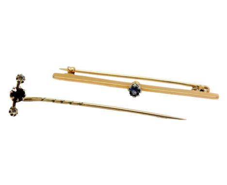An Edwardian ruby and diamond stick pin, in yellow metal, engraved 735, 0.9g, and a sapphire set bar brooch, in yellow metal,