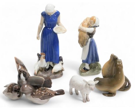 A group of Royal Copenhagen and Bing &amp; Grondhal figures, comprising a lady feeding chickens, no 2220, a lady with a bale 