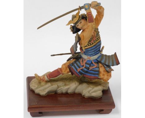 A Franklin Mint bisque porcelain figure, modelled as a Samurai by Sum Nakamura, on a hardwood stand, 30cm high overall.