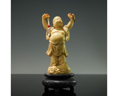 Carved resin figurine depicting the Laughing Buddha, traditionally associated with abundance and good fortune. The figure is 