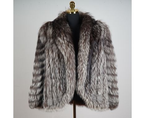 A voluminous and exquisitely constructed fox fur coat with nylon and Bemberg lining.  The coat showcases the characteristic h