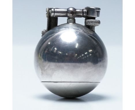 A vintage Dunhill Unique round lighter in silver, featuring a distinctive spherical design. Marked with patent numbers "PAT. 