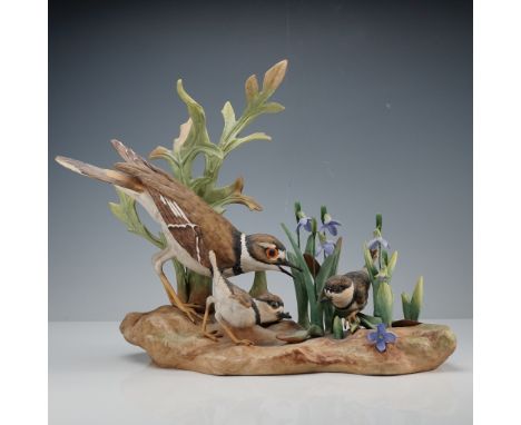 This exquisite Boehm porcelain figurine titled Killdeer (Oxyechus vociferus) captures a tender family scene of a mother killd