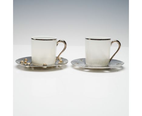 A distinctive pair of designer demitasse cup and saucer sets by celebrated French fashion and accessories designer Edouard Ra