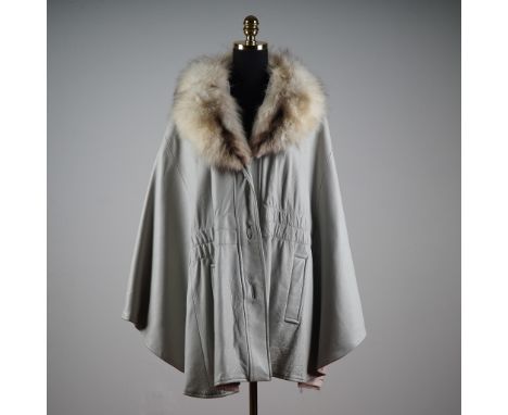 This sophisticated vintage cape coat is crafted from supple grey leather and features an opulent fox fur collar in rich silve
