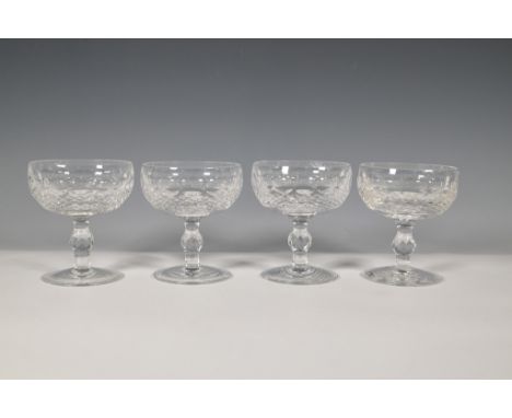 Elegant set of four Waterford crystal champagne coupes featuring intricate crosshatch and fan patterns. Each coupe is expertl
