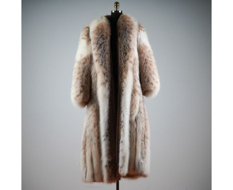 This luxurious full-length mid-century vintage lynx fur coat by Alaskan Custom Built Furs of Kansas City showcases an exquisi