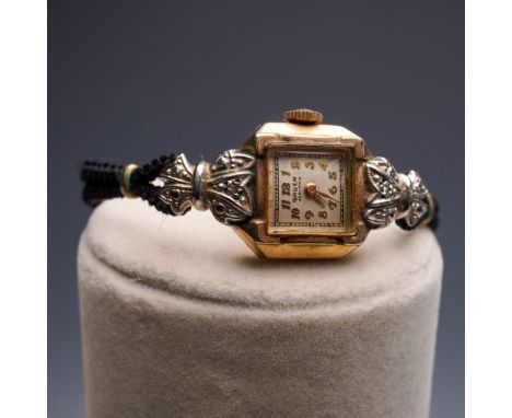 This elegant mid-century ladies' wristwatch is marked Gruen Veri-Thin on the dial and features a 10K gold-filled case with in
